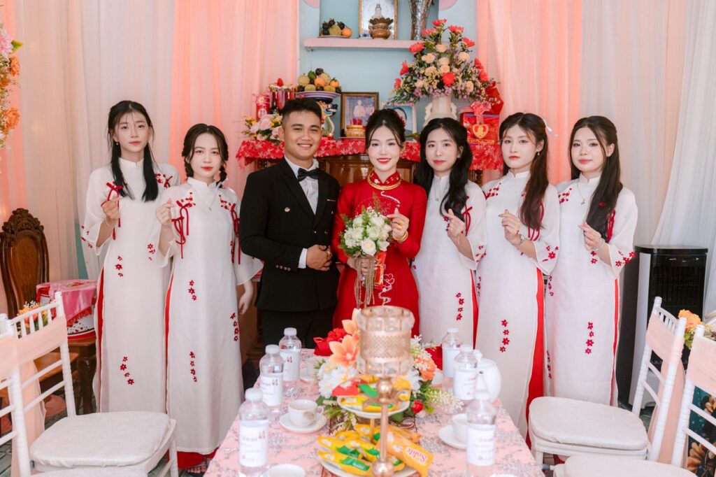 pexels photo 32459256 Beautiful Vietnamese couple with bridesmaids in traditional attire at a wedding ceremony.
