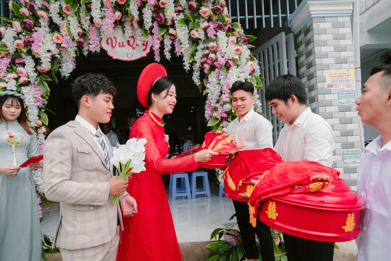 Vibrant Vietnamese wedding ceremony with cultural attire and floral decor.